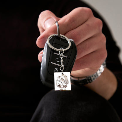Custom photo engraved keychain, held in a gloved hand (2)