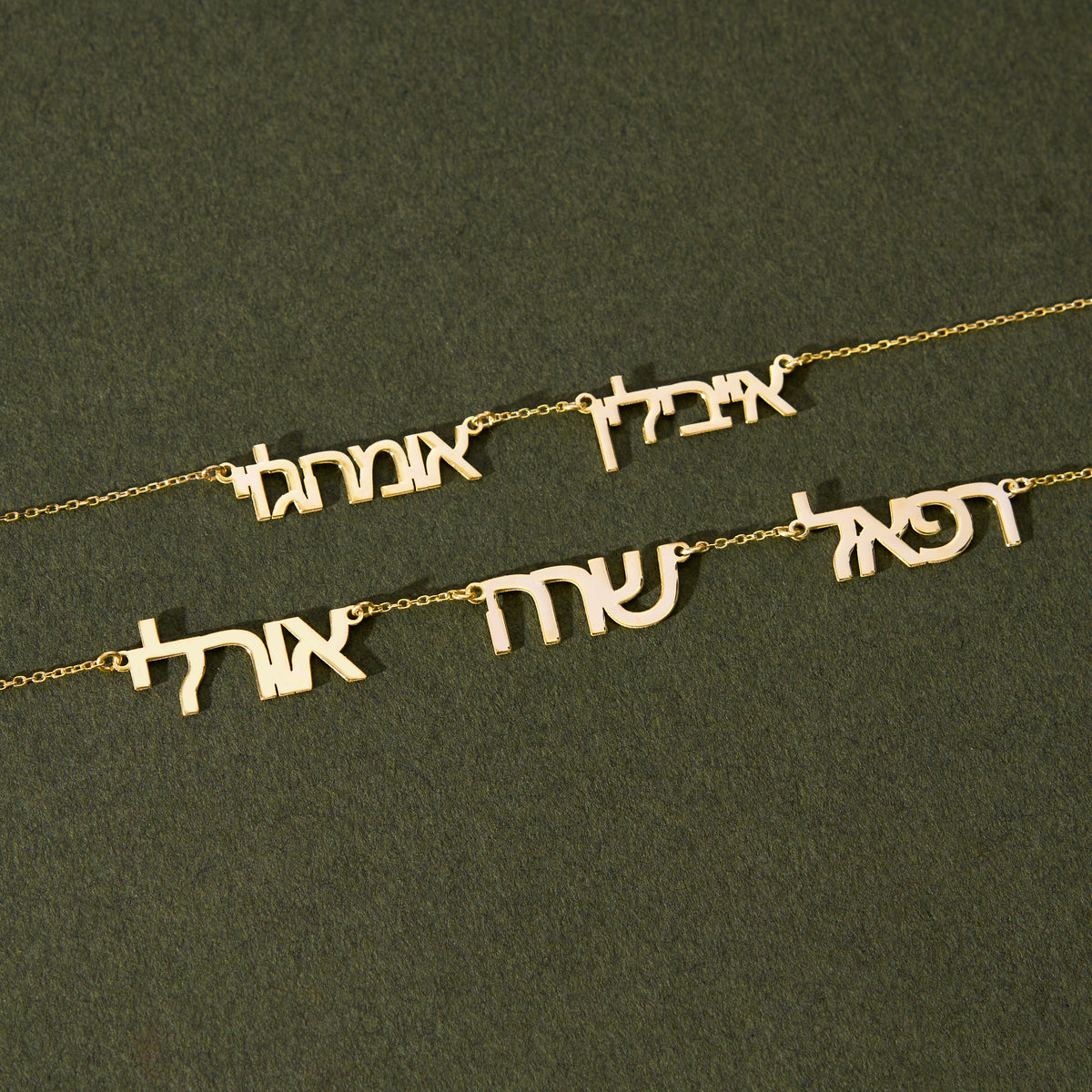 Multiple Hebrew name necklace for up to 4 names, 14K gold vermeil, pendant flat lay on green fabric