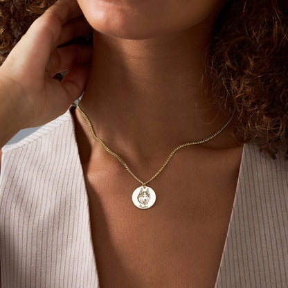 Woman wearing a 14K gold vermeil custom photo necklace with an engraved portrait disc pendant
